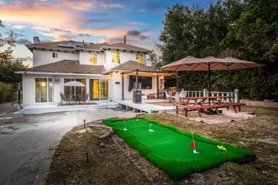 a house with a miniature golf course in the yard at Luxe 6BR Retreat with Trampoline Swing and BBQ Grill in Los Angeles