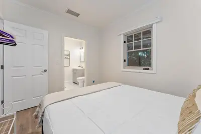 a white bedroom with a bed and a window at Luxe 6BR Retreat with Trampoline Swing and BBQ Grill in Los Angeles