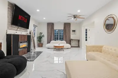 a living room with a couch and a tv at Luxe 6BR Retreat with Trampoline Swing and BBQ Grill in Los Angeles