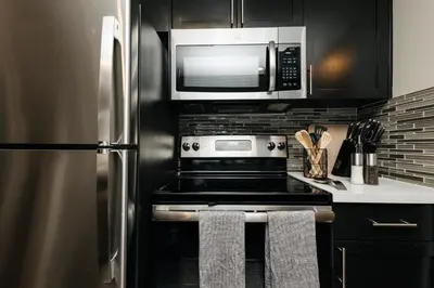a kitchen with a stainless steel refrigerator and microwave at Upscale 1BD - Prime West Hollywood Location in Los Angeles
