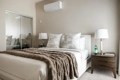 a white bedroom with a large bed with a blanket at Upscale 1BD - Prime West Hollywood Location in Los Angeles