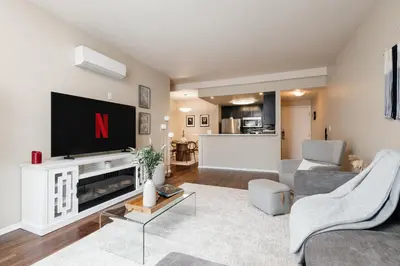 a living room with a tv and a couch and a table at Upscale 1BD - Prime West Hollywood Location in Los Angeles