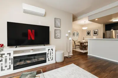 a living room with a large tv on a wall at Upscale 1BD - Prime West Hollywood Location in Los Angeles