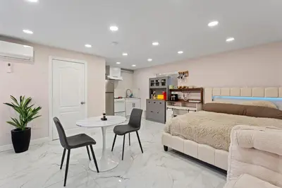 a bedroom with a bed and a table and chairs at Sleek Premium Studio Near The Grove & Fairfax in Los Angeles
