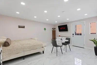 a bedroom with a bed and a table with chairs at Sleek Premium Studio Near The Grove & Fairfax in Los Angeles