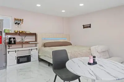 a bedroom with a table and a bed and a table and chair at Sleek Premium Studio Near The Grove & Fairfax in Los Angeles