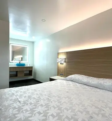 a bedroom with a large bed and a window at Nubell Motel in Bell