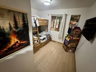 a room with a bedroom with a bed and a window at Lakewood Timber Lodge Peaceful Private in Big Bear Lake