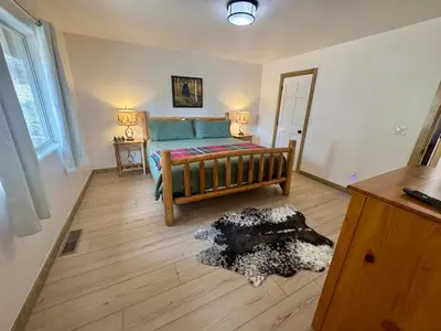 a living room with a bed and a rug at Lakewood Timber Lodge Peaceful Private in Big Bear Lake