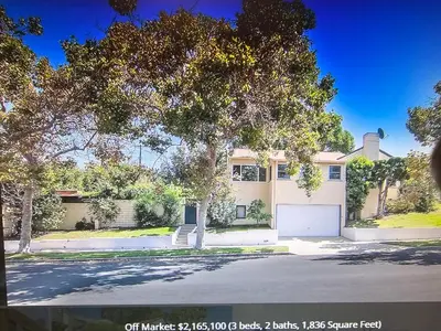 a large white house with a garage at The Rochester house in Los Angeles