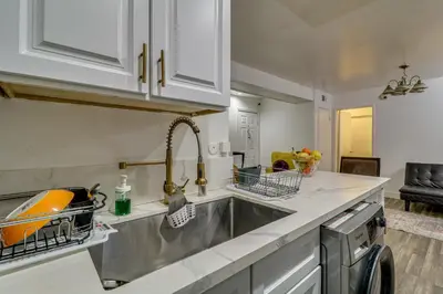 a kitchen with white cabinets and a sink at Extended Stay in the Valley Gated and Convenient! in Tarzana