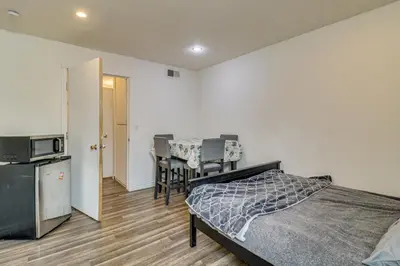 a bedroom with a bed and a table and chairs at Extended Stay in the Valley Gated and Convenient! in Tarzana