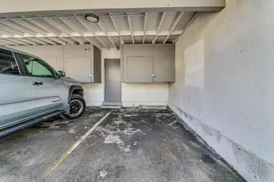 a parking garage with a car parked in it at Extended Stay in the Valley Gated and Convenient! in Tarzana