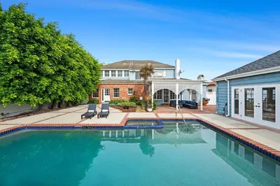 a swimming pool in front of a house at Spacious 5BR LA Villa with Pool Spa & Game Room in Los Angeles