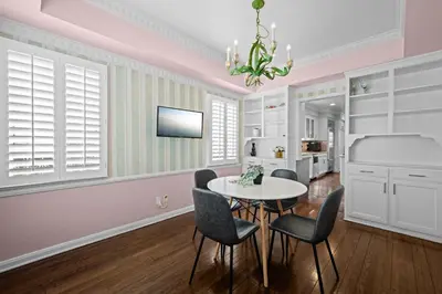 a dining room with pink walls and a table and chairs at Spacious 5BR LA Villa with Pool Spa & Game Room in Los Angeles