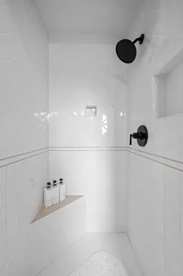 a white bathroom with a shower with three toilets at Spacious 5BR LA Villa with Pool Spa & Game Room in Los Angeles