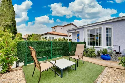 a patio with two chairs and a table on the grass at Mar Vista Beach Escape 2BR with Relaxing Yard in Los Angeles
