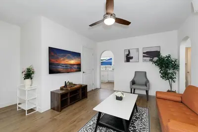 a living room with a couch and a ceiling fan at Mar Vista Beach Escape 2BR with Relaxing Yard in Los Angeles