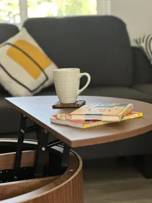 a coffee table with a cup and books on it at Walkable to SoFi, Intuit Dome, Kia Forum World Cup in Inglewood