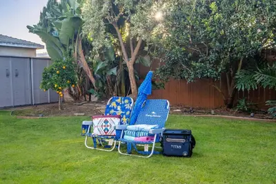 two chairs sitting on the grass in a yard at Luxury Retreat with Private Yard close to Beaches and FIFA Sleeps 10 in Torrance