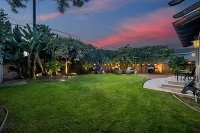 a backyard at night with a grass yard at Luxury Retreat with Private Yard close to Beaches and FIFA Sleeps 10 in Torrance