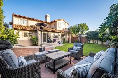 a patio with chairs and a table and a house at Luxury Retreat with Private Yard close to Beaches and FIFA Sleeps 10 in Torrance
