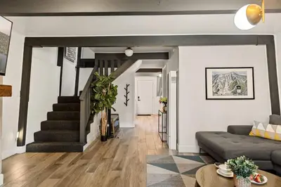a living room with a couch and a staircase at Hearthmoon Haven in Big Bear Lake