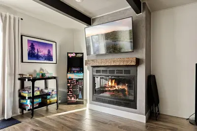 a fireplace in a living room with a fire place at Hearthmoon Haven in Big Bear Lake