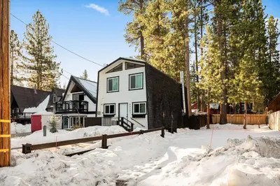 a house in the snow with a fence at Hearthmoon Haven in Big Bear Lake