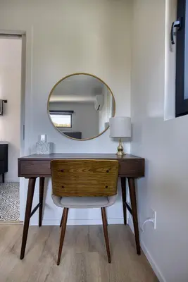 a dressing table with a mirror on a wall at Brand-New MCM Guesthouse in West Los Angeles in Los Angeles