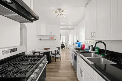 a kitchen with white cabinets and a stove top oven at Remodeled 1BR LA Apartment with full kitchen in Los Angeles