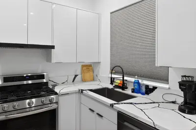 a white kitchen with a sink and a stove at #01 Spacious 3B3B Near Koreatown & Hollywood, Central LA in Los Angeles