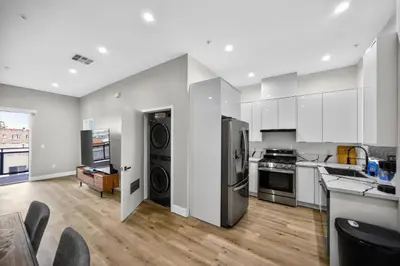 a large kitchen with stainless steel appliances and a living room at #01 Spacious 3B3B Near Koreatown & Hollywood, Central LA in Los Angeles