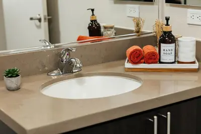 a bathroom counter with a sink and a mirror at Cute 1Bedroom apartment with pool view, parking and GYM in Los Angeles