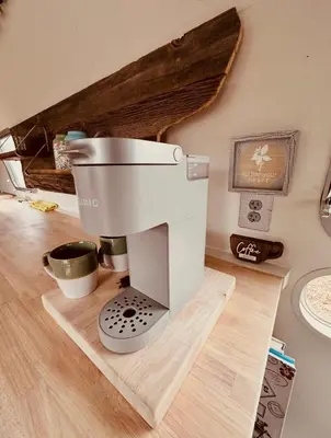 a coffee machine sitting on a wooden cutting board at Zaromelranch