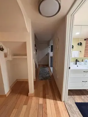 a hallway of a house with a sink and a mirror at Lakeview Location Hot tub Tesla Charger tree house in Big Bear Lake