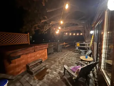 a room with chairs and a table in a building at Lakeview Location Hot tub Tesla Charger tree house in Big Bear Lake