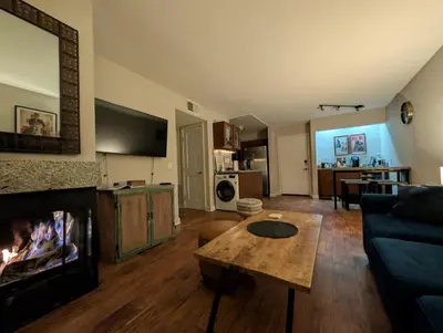 a living room with a couch and a fireplace at ENSUITE MASTER BEDROOM IN WEST HOLLYWOOD - super host in Los Angeles