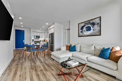 a living room with a white couch and a table at Nautical Knees Water View Pool, Jacuzzi and Gym in Los Angeles