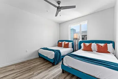 a bedroom with two beds and a window at Nautical Knees Water View Pool, Jacuzzi and Gym in Los Angeles