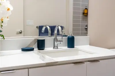 a bathroom with a sink and a mirror at Nautical Knees Water View Pool, Jacuzzi and Gym in Los Angeles