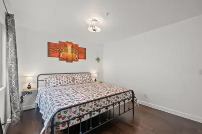 a bedroom with a bed and a painting on the wall at LuxuryCondo DTAlhambra Near Starbucks Free2Parking in Alhambra