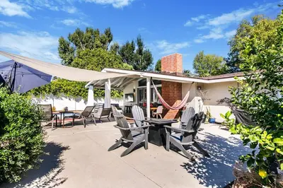 a patio with chairs and a table under a canopy at SoCal Retreat with Pool and Spacious Backyard in Canoga Park