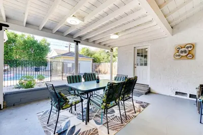 a patio with a table and chairs on it at Valley Oasis Pool Hot Tub Near Universal in Garnsey