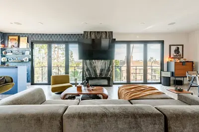 a living room with a couch and a fireplace at Abracadabra Ultra Luxury Private Residence in Los Angeles