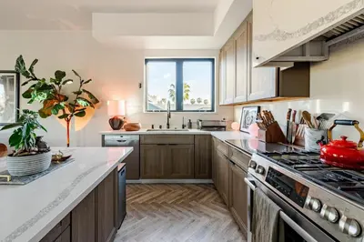 a kitchen with wooden cabinets and a stove top oven at Abracadabra Ultra Luxury Private Residence in Los Angeles