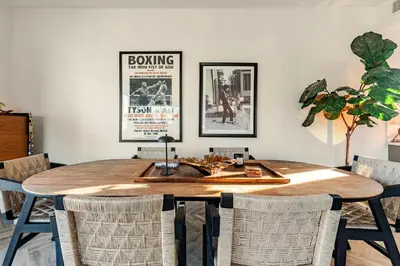 a dining room with a wooden table and chairs at Abracadabra Ultra Luxury Private Residence in Los Angeles