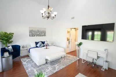 a living room with a white bed and a desk at silver in Chatsworth