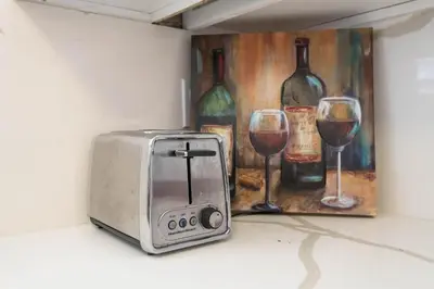 a toaster next to a painting of wine glasses at Cozy 2BR Near Disneyland and Convention Center in Anaheim