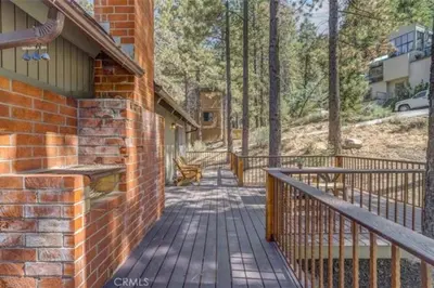 a brick house with a walkway leading to a porch at Pet Friendly 3BR Pine Mountain Club Cabin with King Bed and Pool Access in Pine Mountain Club